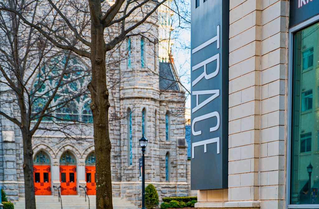 a sign on the side of a building in front of a church