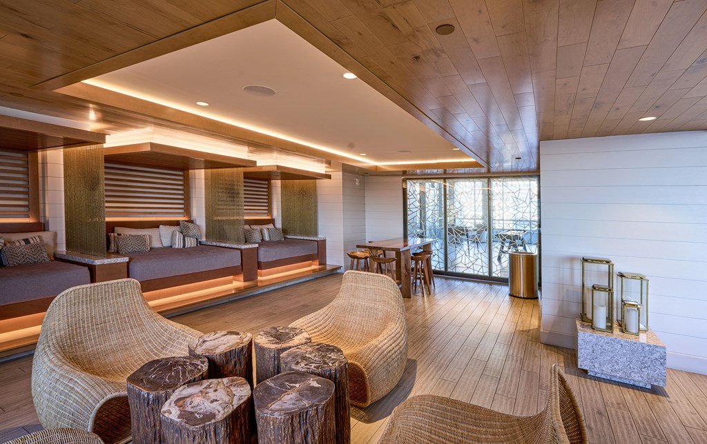 a living room with a couch and chairs and a table