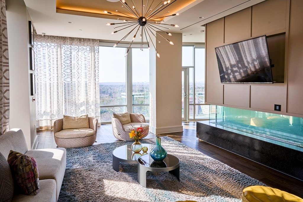 a living room with couches and a coffee table and a television