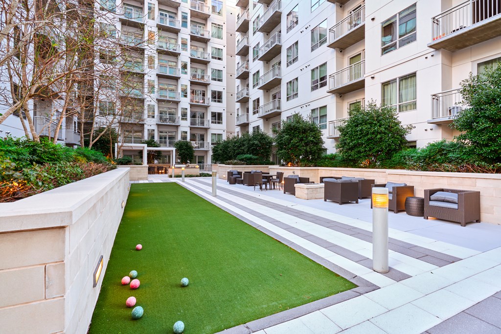 an apartment yard with bocce balls in front of an apartment building