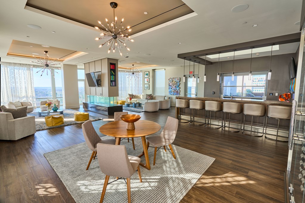 a dining room and living room with a table and chairs