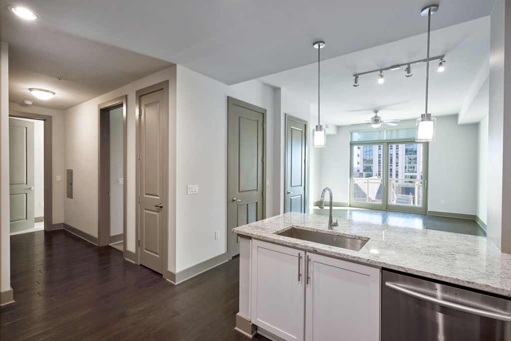 an empty kitchen with a sink and a counter top