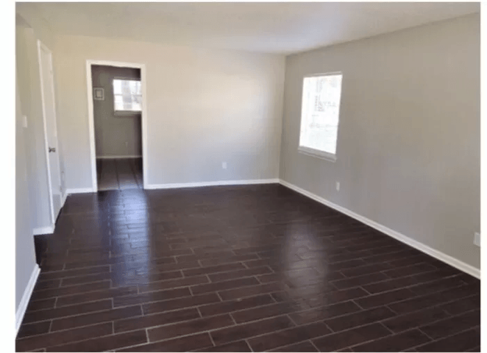 a empty living room with a wood floor