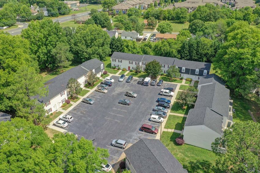 an aerial view of a parking lot and several houses