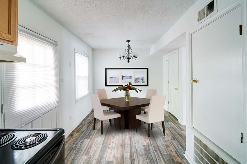 a dining room with a wooden table and chairs