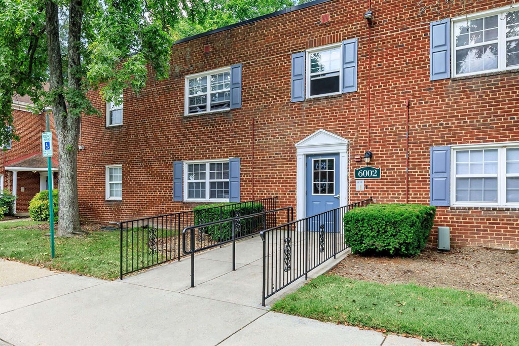a brick building with a blue door at Parkland Village, Maryland, 20747