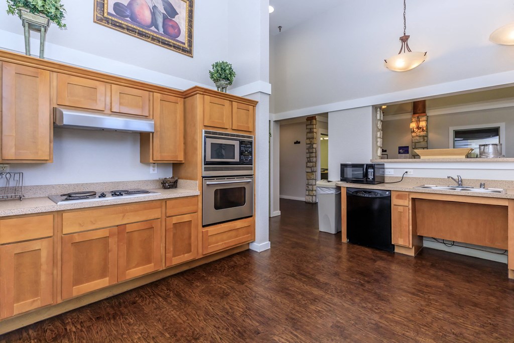 a kitchen with wooden cabinets and stainless steel appliances