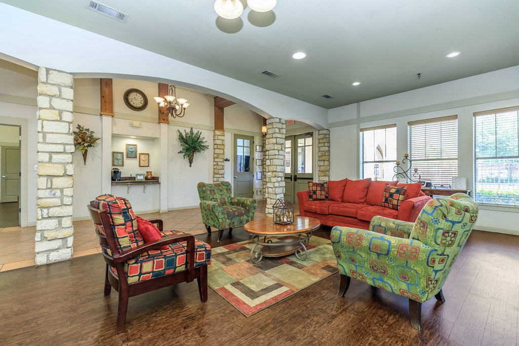 a living room with a couch and chairs and a table