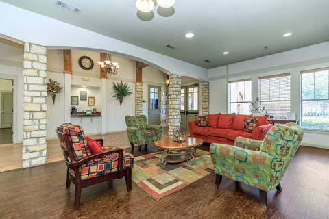 A living room with a red couch and a fireplace.