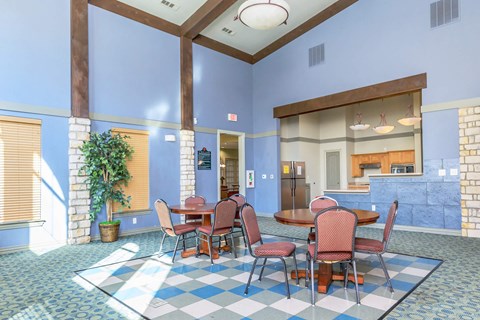 A dining room with a checkered floor and a table set for four.