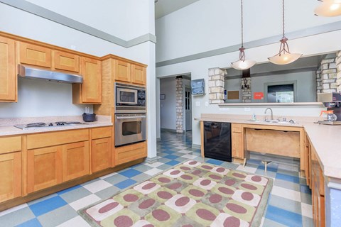 a kitchen with wooden cabinets and stainless steel appliances