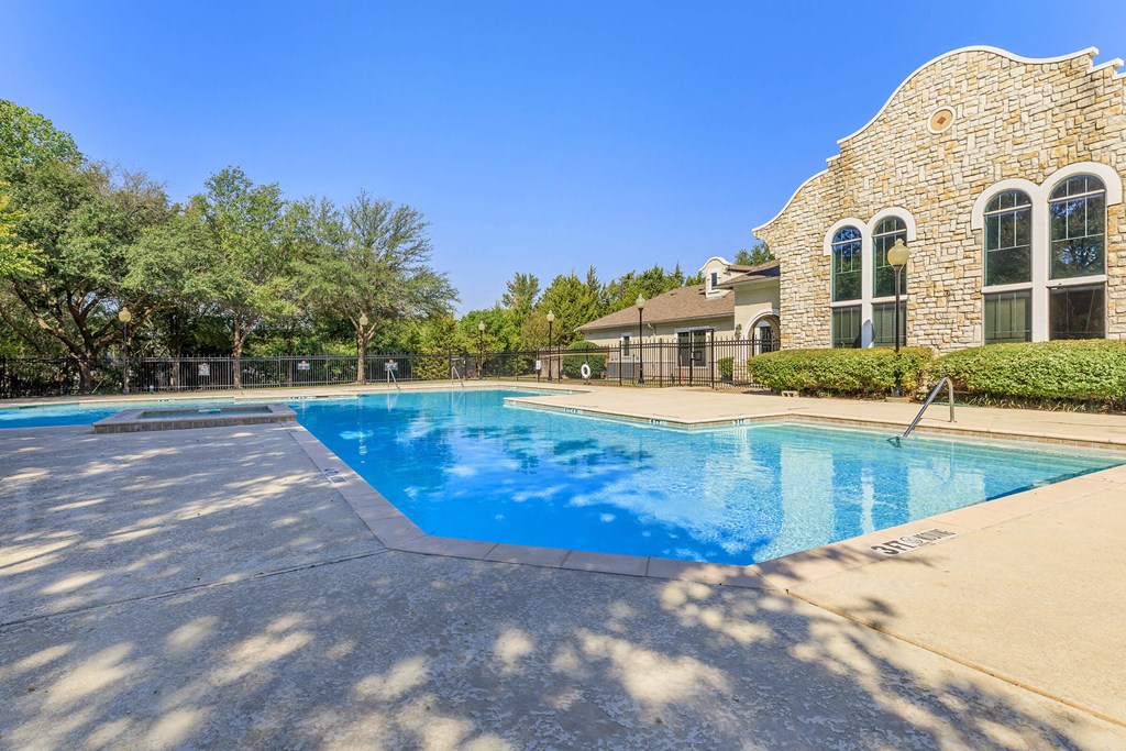 A large swimming pool in front of a house.