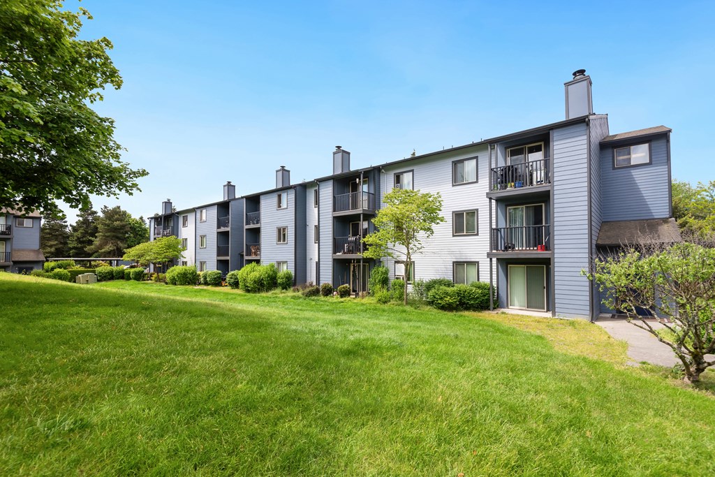 exterior view of apartment buildings on a sunny day at Eagles Landing Apartments, Everett, 98204