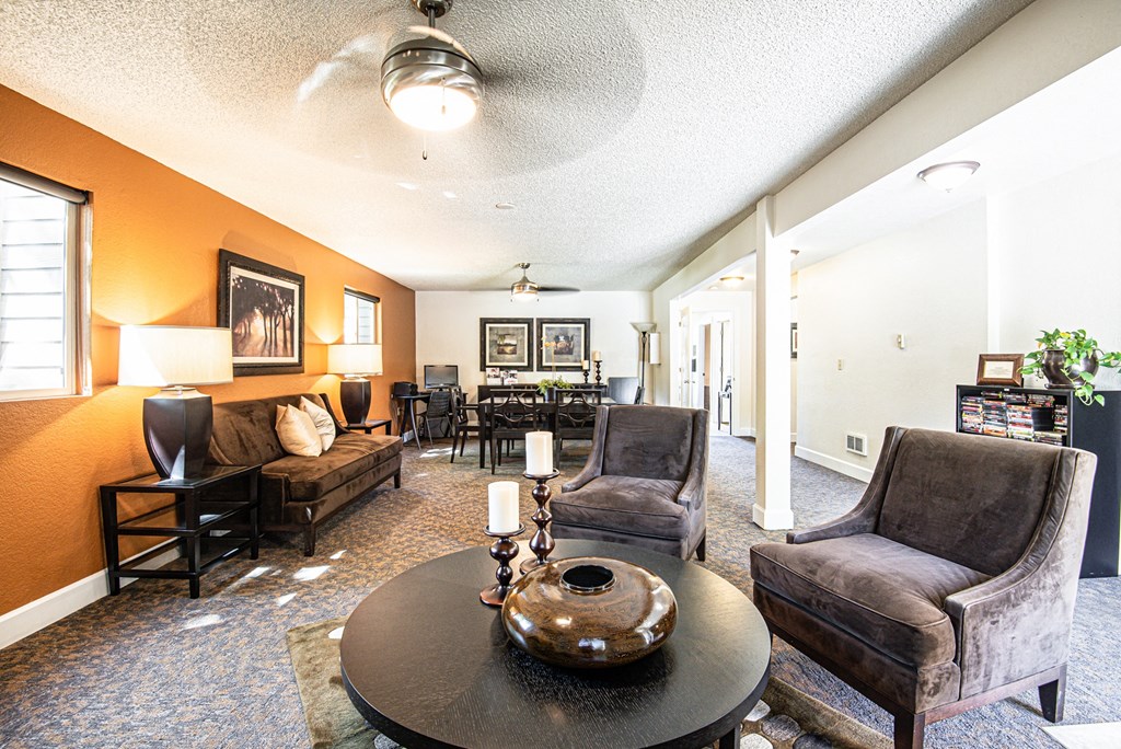 a living room with couches and chairs and a table at Eagles Landing Apartments, Everett, WA