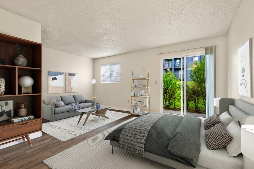 a bedroom with a bed and a couch and a living room at Eagles Landing Apartments, Everett Washington  