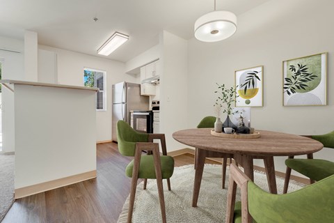a living room and dining room with a table and chairs at Sage Apartments, Everett