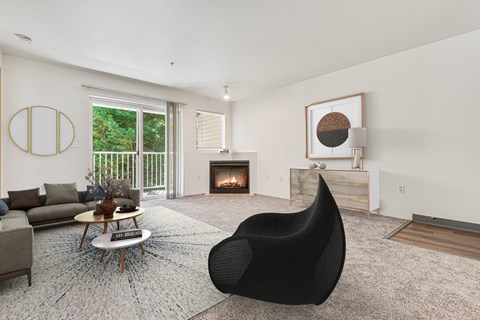 a living room with a black chair and a fireplace at Sage Apartments, Everett, WA, 98204