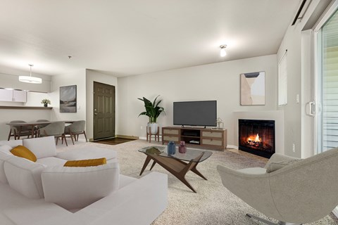 a living room with a couch and a chair and a television and a fireplace at Sage Apartments, Washington, 98204