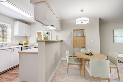 a dining room and kitchen with a table and chairs at Sage Apartments, Everett, Washington