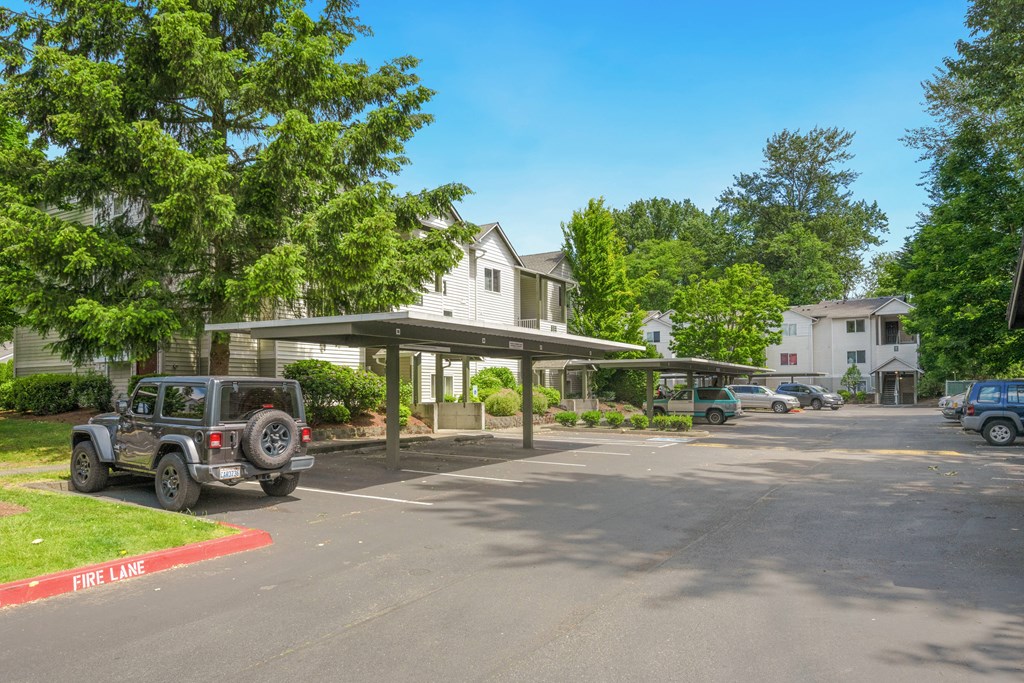 a parking lot with a jeep parked in front of a house