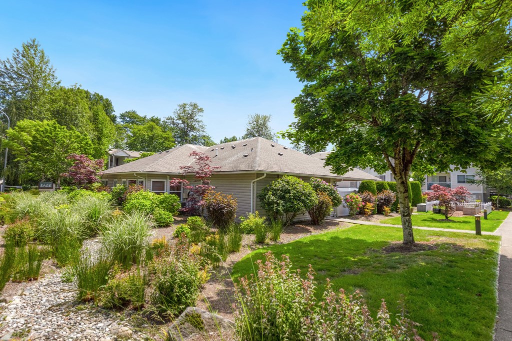 a home with a landscaped front yard and a tree