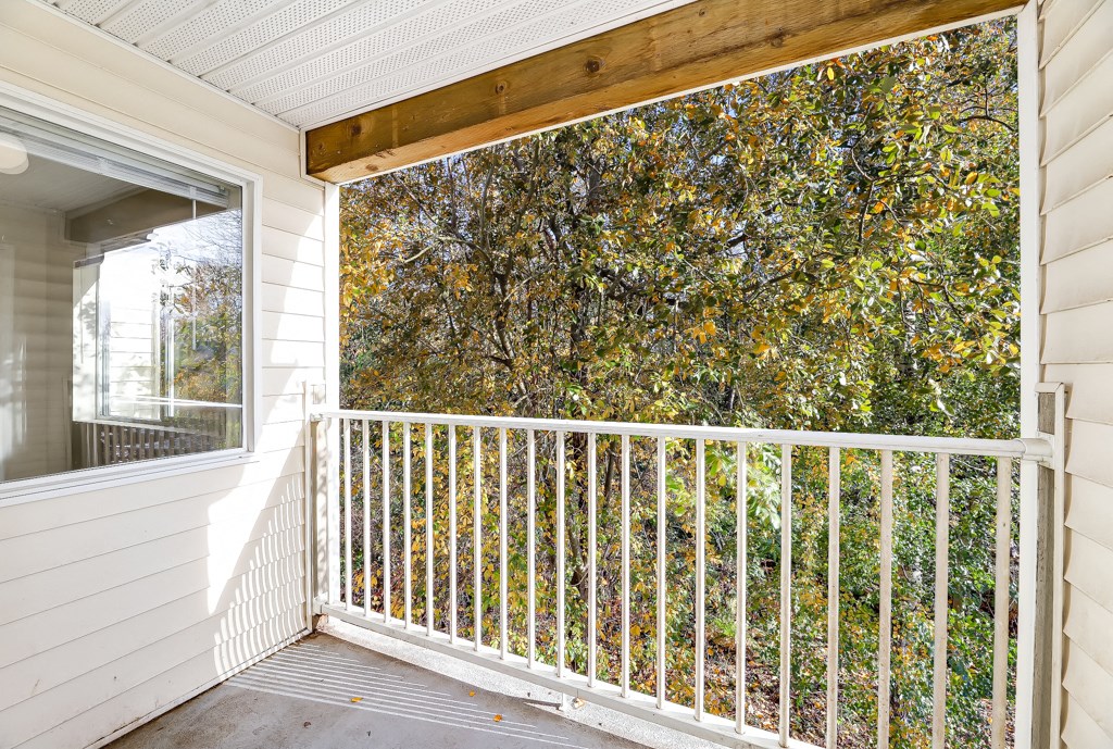 a porch with a white railing and a window