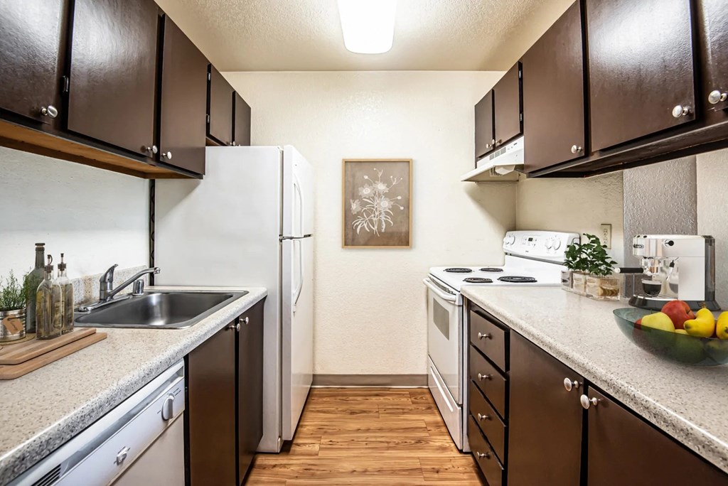 full kitchen with white appliances and wood flooring at the preserve at Eagles Landing Apartments, Everett, WA