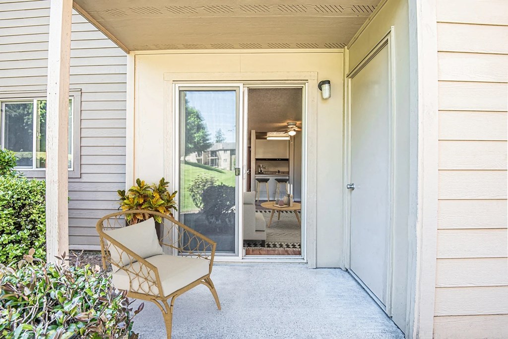 the front porch of a house with a chair and a door at Eagles Landing Apartments, Everett, 98204