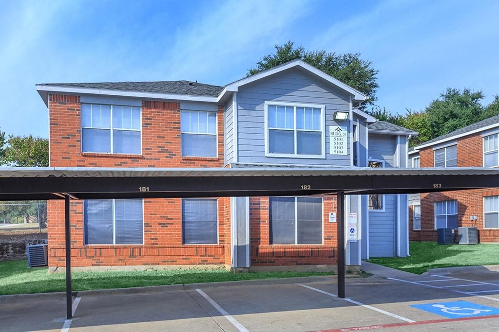 the front of a house with a parking lot in front of it