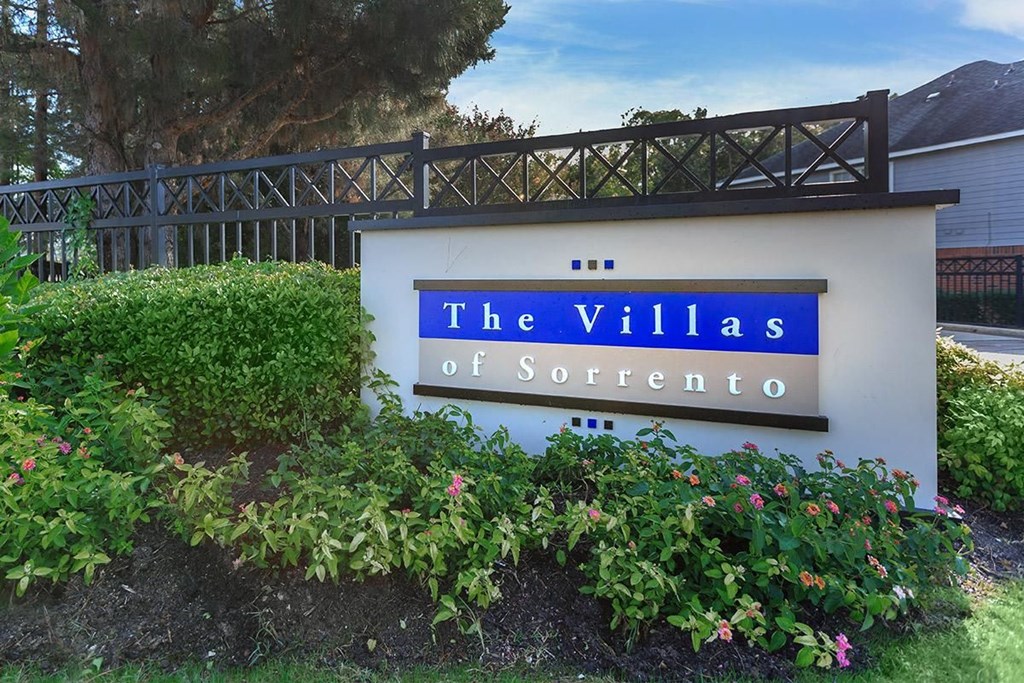 a sign for the villas in front of a house
