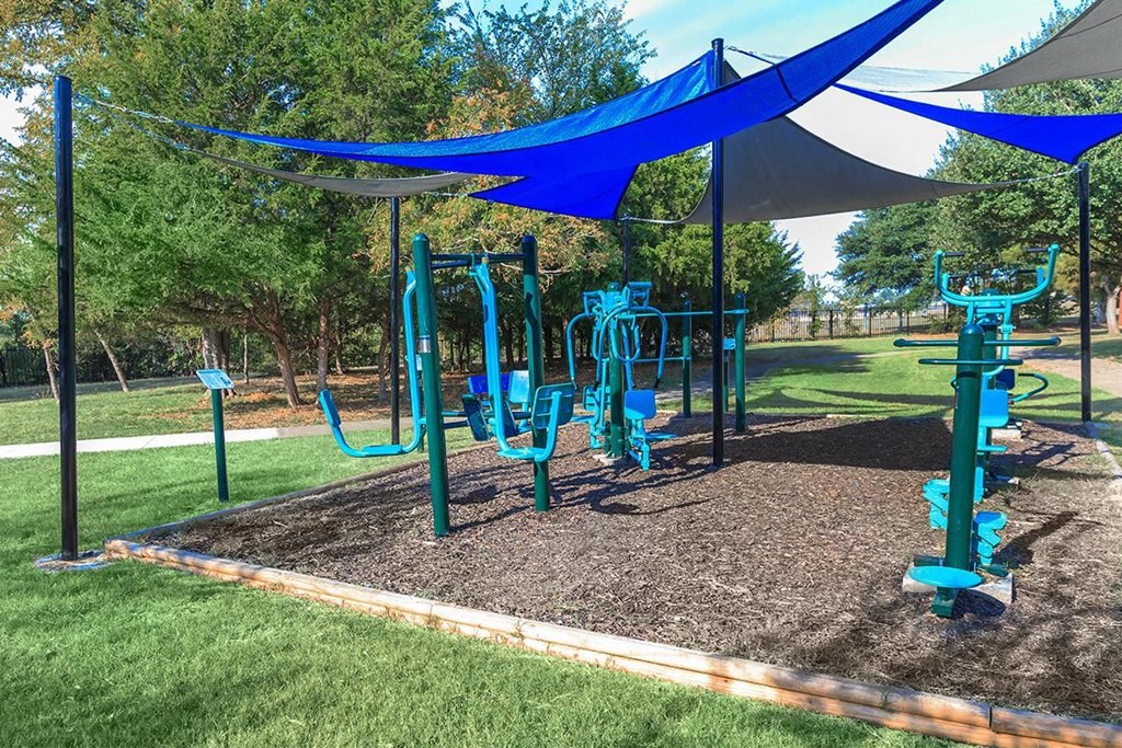 a playground with blue equipment in a park