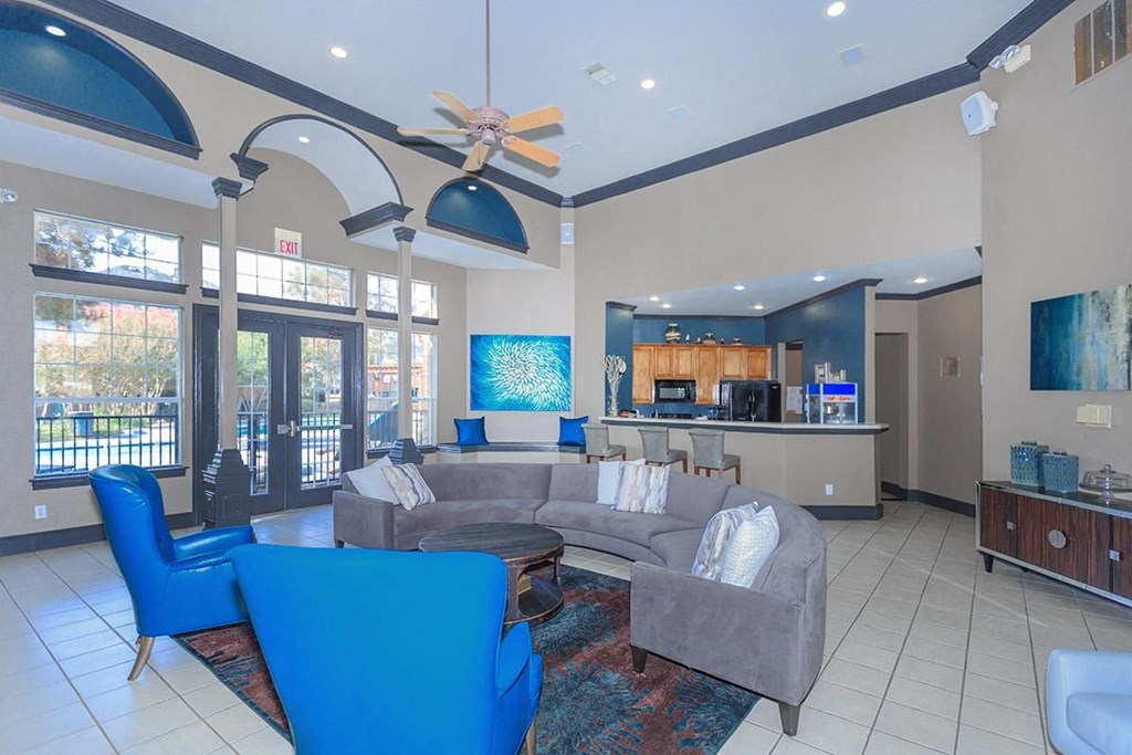 a living room with blue chairs and a couch