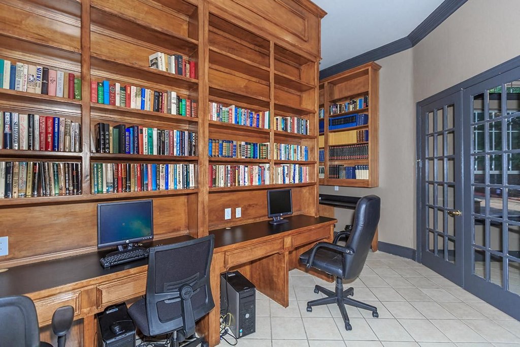 a library with desks and chairs and bookshelves