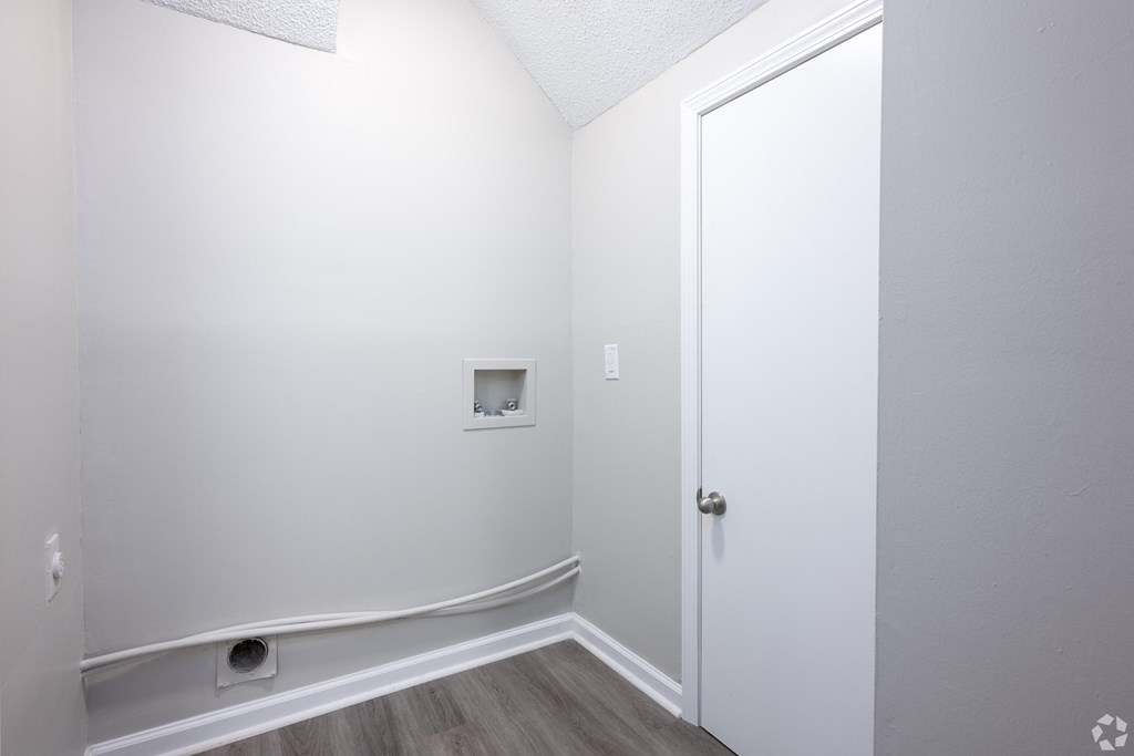 an empty room with white walls and a white door