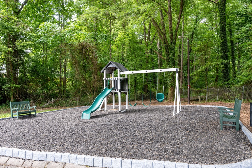 a playground with a swing set and a slide
