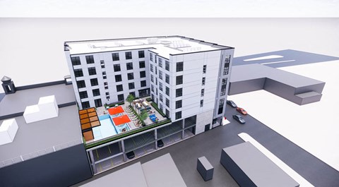 an aerial view of an apartment building with a parking lot