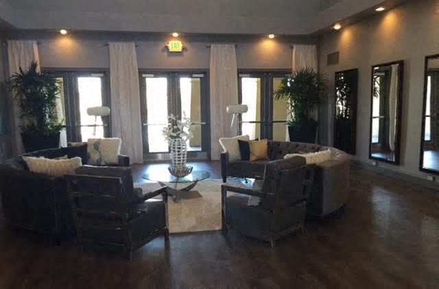 a large living room with couches and chairs