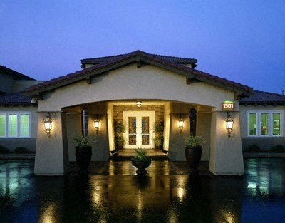 a house with lights on in the rain