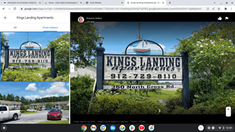 a screenshot of a facebook page with a sign for kings landing apartments