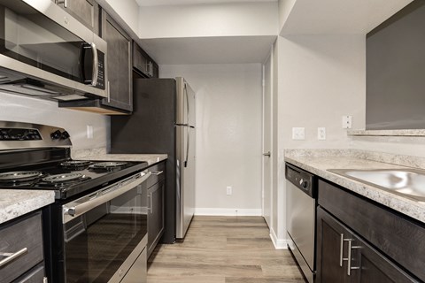 a kitchen with stainless steel appliances and marble counter tops