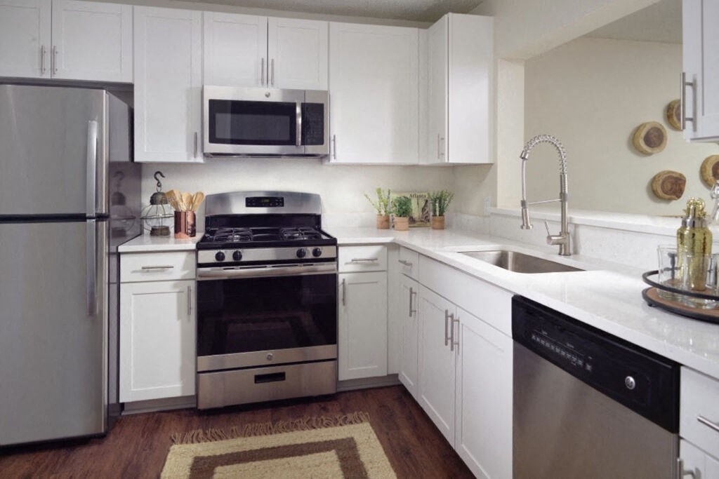 Renovated Kitchen with stainless steel appliances and quartz countertops at Elme Cumberland Apartments, Smyrna, Georgia