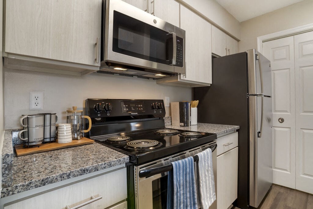 Renovated Kitchen with stainless steel appliances and granite countertops at Elme Germantown, Germantown Maryland