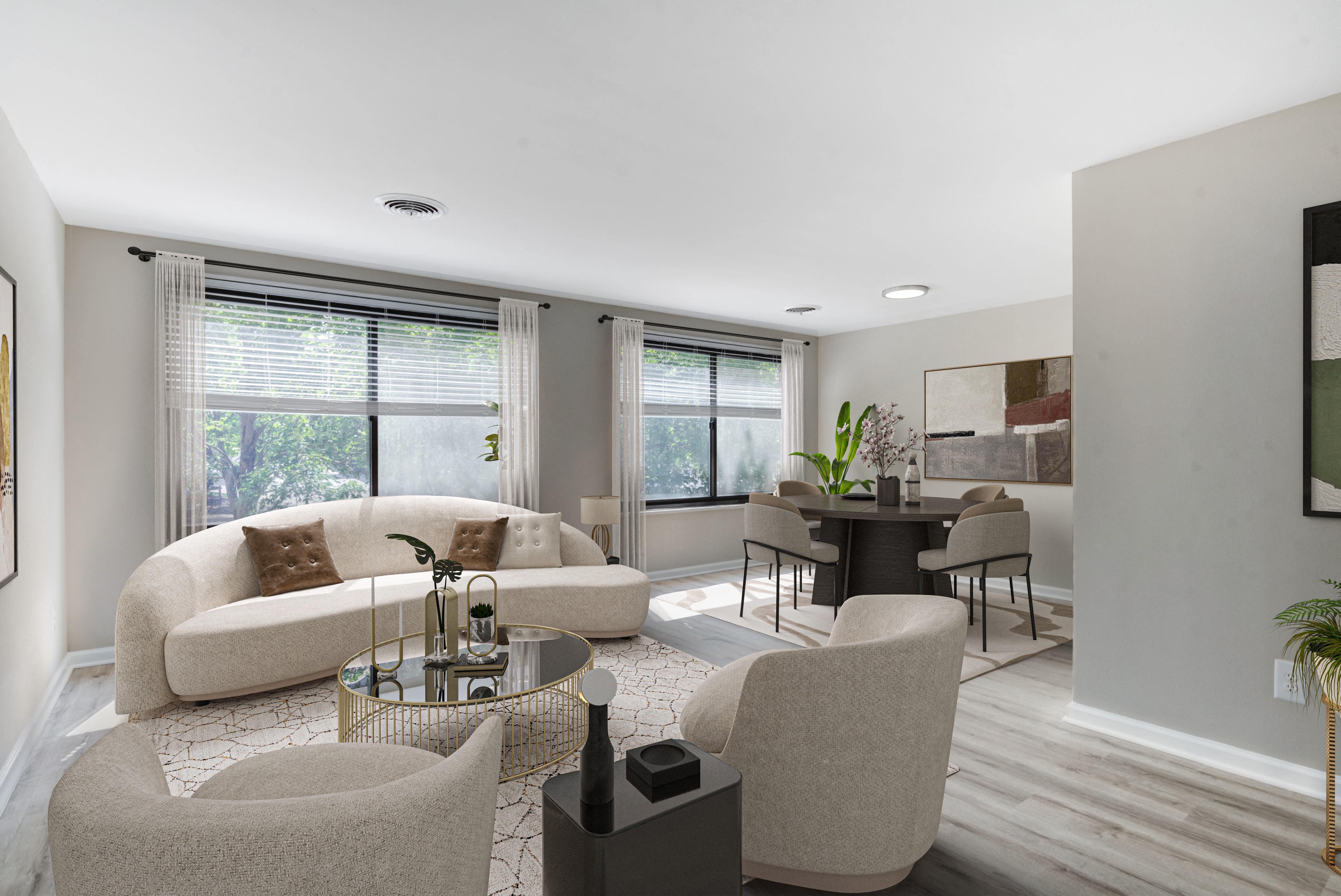 a living room and dining room with white walls and wood floors