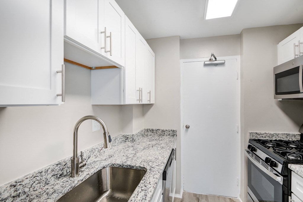 Renovated Kitchen with stainless steel appliances and granite countertops at Park Adams Arlington, VA