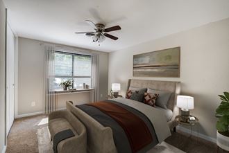 a bedroom with a bed and a ceiling fan - Photo Gallery 3