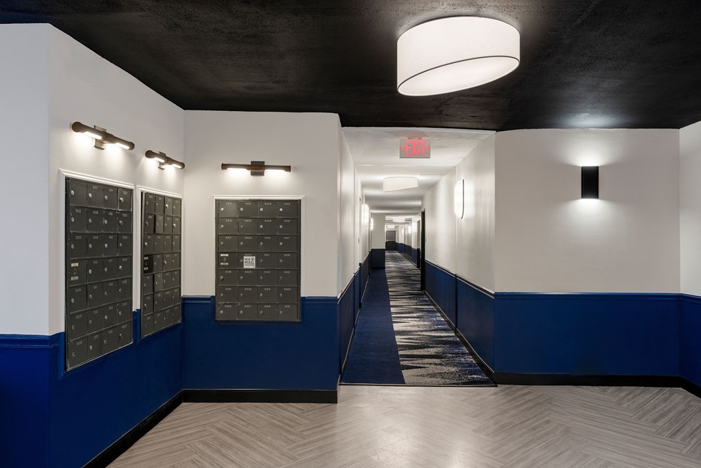 A hallway with lockers with white and blue walls at Elme Alexandria, Virginia, 22304