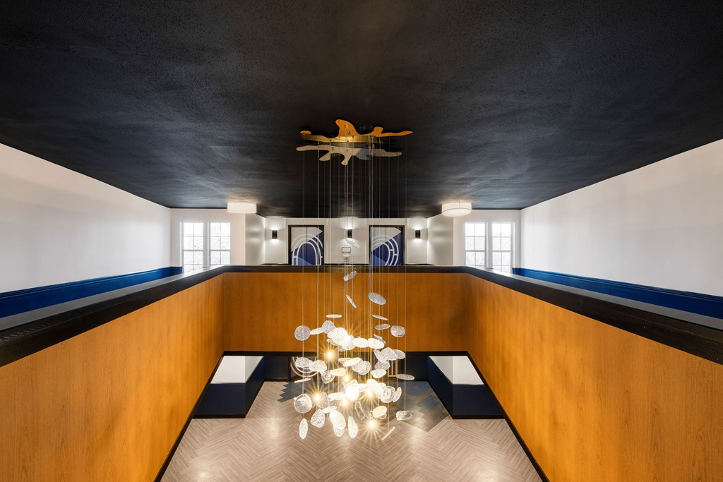 Glass chandelier hanging from a navy blue ceiling at Elme Alexandria, Virginia, 22304