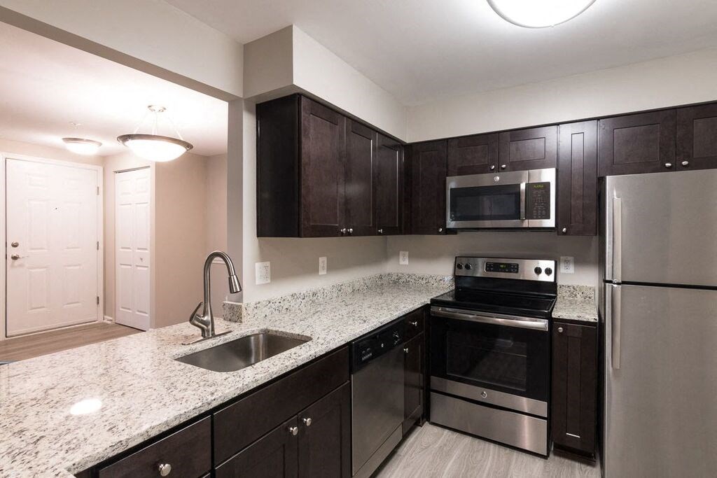 Kitchen with stainless steel appliances and granite countertops at Elme Manassas, Virginia