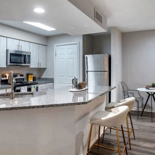 Renovated kitchen with stainless steel appliances and granite countertops at Elme Alexandria, Virginia