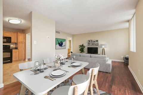 A dining room with a white table set for four at The Ashby at McLean, McLean Virginia